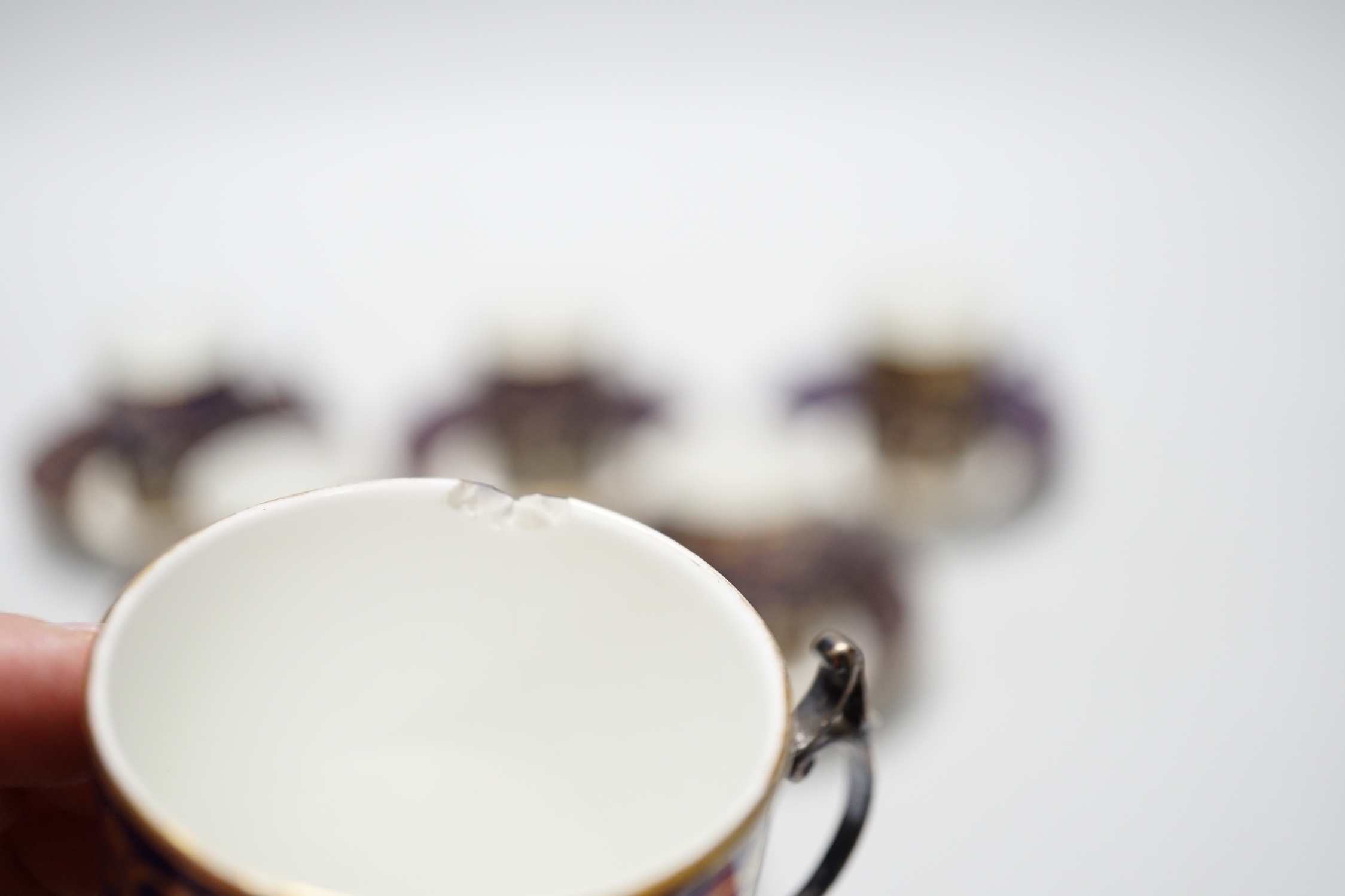 A set of six silver jacketed porcelain cups and saucers